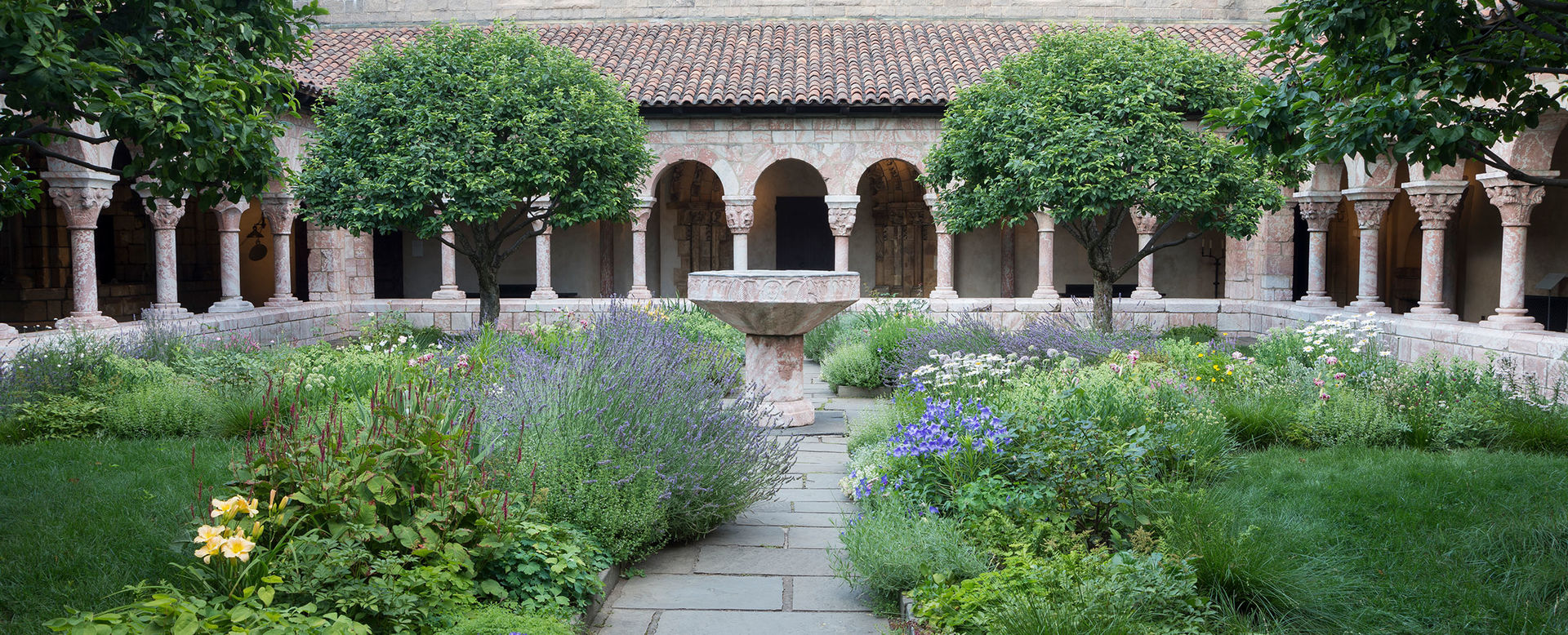 Gardens of the cloisters showing arching architecture and herb gardens